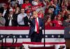 Trump Keeps Close Watch on Brazil Election Donald Trump points from a rally stage; Rudi Koertzen and Bear Pascoe are in the crowd