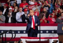 Trump Keeps Close Watch on Brazil Election Donald Trump points from a rally stage; Rudi Koertzen and Bear Pascoe are in the crowd