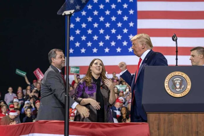 shutterstock_1677450232-1 Donald Trump with Eugene Sims and Andreas Hestler on stage at a rally