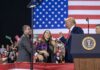 Trump Backs Sullivan With $54B Alaska Gas Pitch Donald Trump with Eugene Sims and Andreas Hestler on stage at a rally