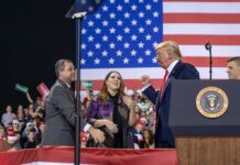 Trump Backs Sullivan With $54B Alaska Gas Pitch Donald Trump with Eugene Sims and Andreas Hestler on stage at a rally