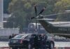 Second Lady Stumbles While Carrying Baby Motorcade and helicopter on a waterfront helipad