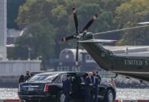 Second Lady Stumbles While Carrying Baby Motorcade and helicopter on a waterfront helipad
