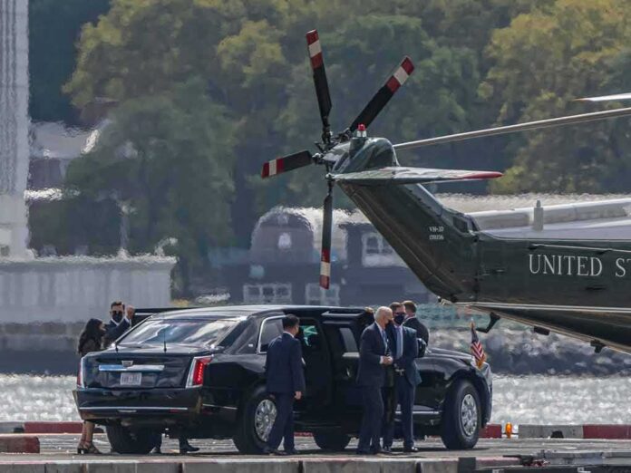 Motorcade and helicopter on a waterfront helipad