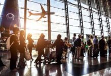 Riyadh Airport Strike Sends Travelers Fleeing to Bahrain Passengers queue inside an airport terminal at sunset
