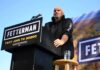 California Tax Plan Would Shield First $150K Speaker at outdoor podium with campaign signs