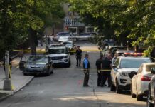 Chicago Shooting Raises Questions About Public Safety Police officers secure a residential street with patrol cars and yellow tape