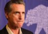 Midterms Become a Test of Trump’s Power Gavin Newsom at a press event with a purple backdrop