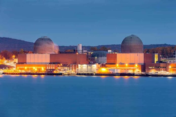nuclear power plant with two domed reactor buildings by water at dusk
