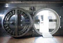 Bank vault door open with circular steel entrance