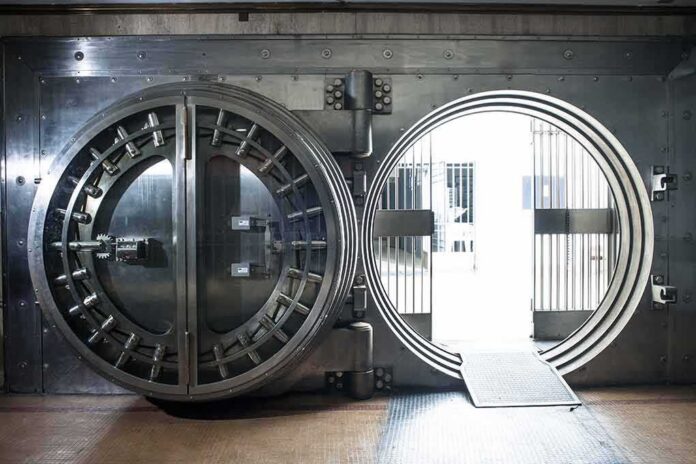 shutterstock_761867557 Bank vault door open with circular steel entrance